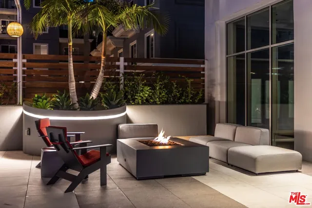 a living room with furniture a rug and white walls
