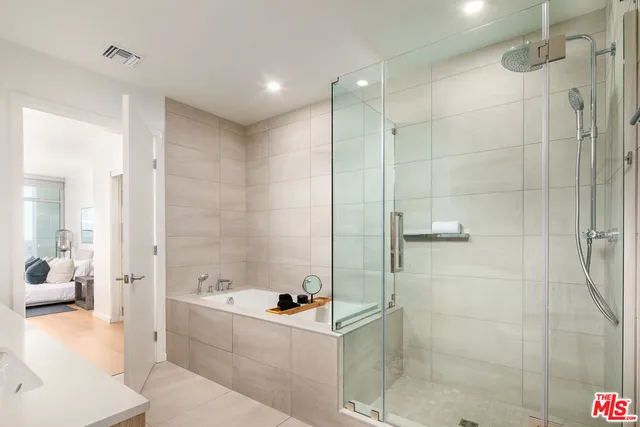 a bathroom with a bathtub and a shower