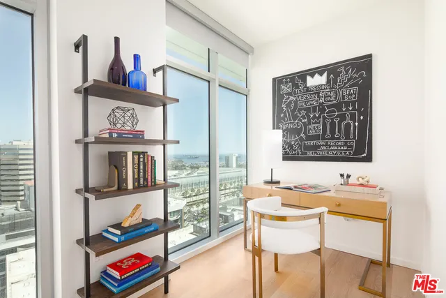 a very nice looking room with many windows and furniture