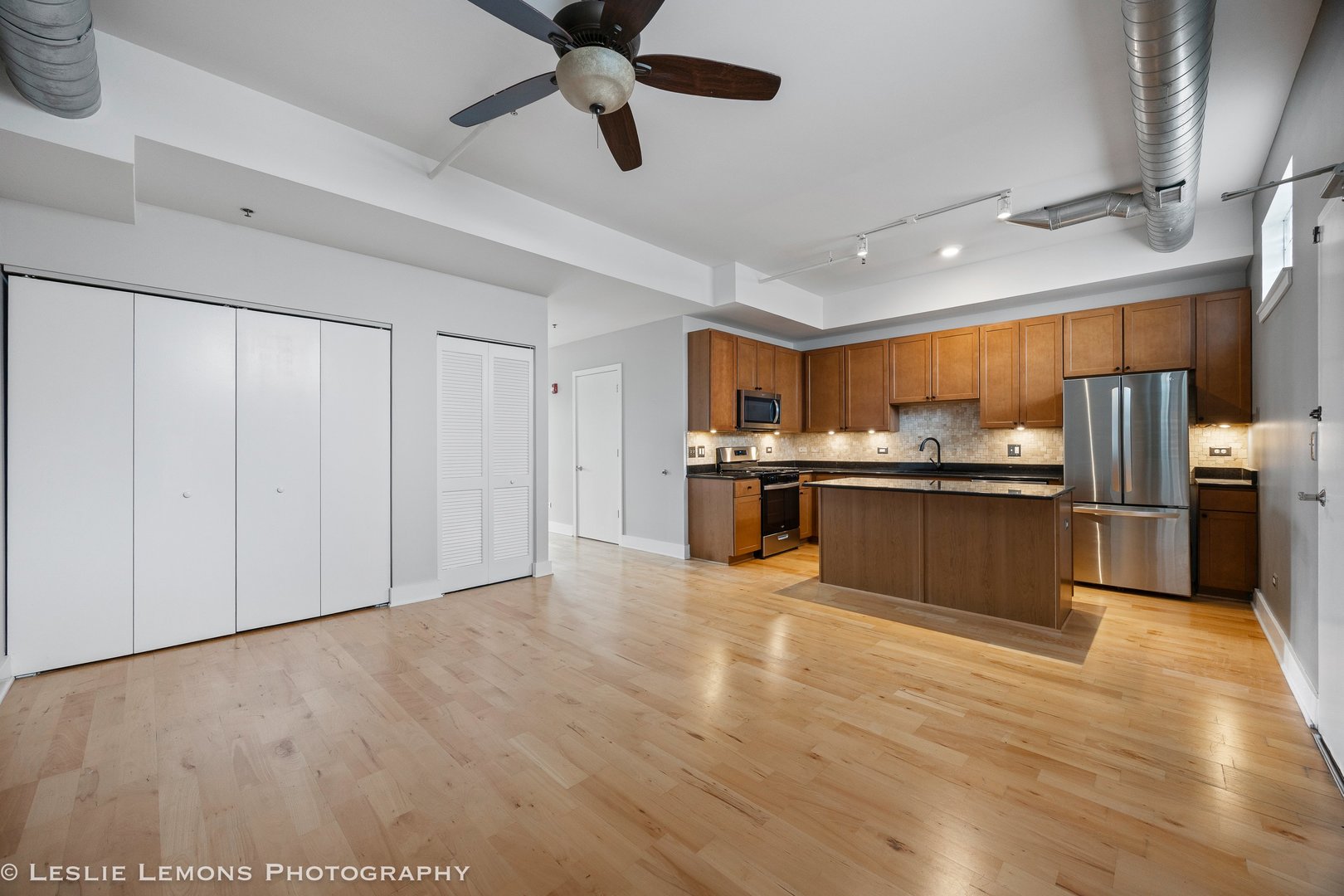354 River Street, Unit 3407 Lemont, IL 60439 - Photo 7 of 15 a kitchen with stainless steel appliances kitchen island granite countertop a refrigerator and a sink