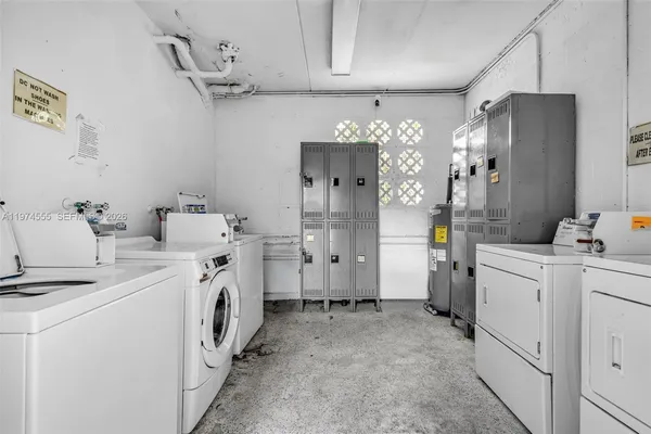 a view of a storage & utility room with closet dryer and washer