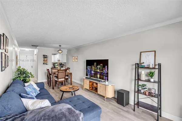 a living room with furniture and a book shelf