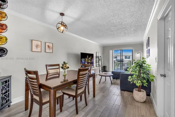 a living room with furniture a potted plant and a window