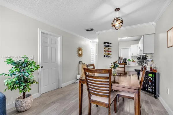 a view of a dining room with furniture and wooden floor