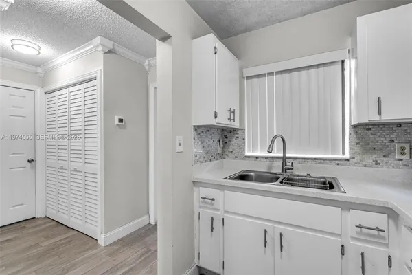 a kitchen with a sink and cabinets