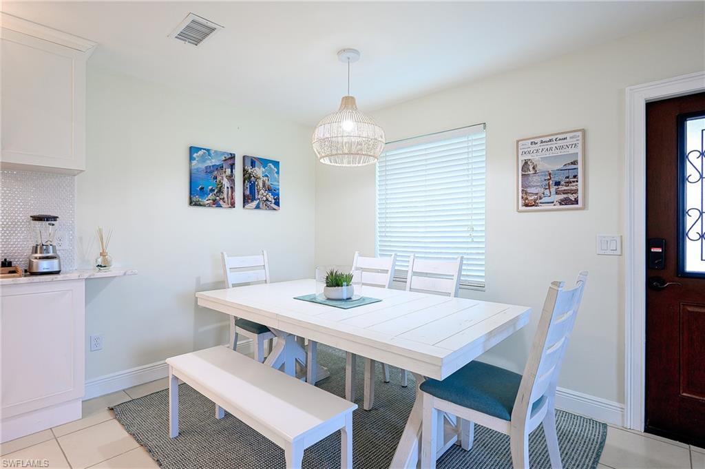 757 101st Avenue North Naples, FL 34108 - Photo 12 of 33 a view of a dining room with furniture window and wooden floor
