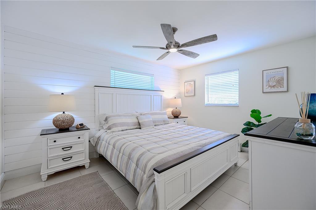 757 101st Avenue North Naples, FL 34108 - Photo 13 of 33 a bedroom with a bed and a chandelier