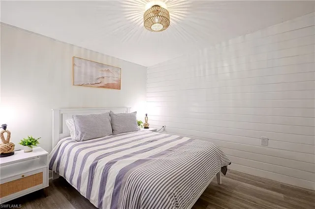 a bedroom with a bed and a lamp