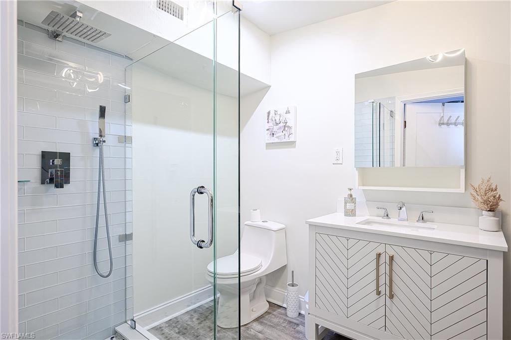 757 101st Avenue North Naples, FL 34108 - Photo 19 of 33 a bathroom with a sink vanity toilet and shower