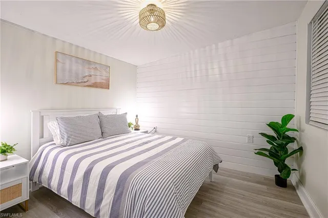 a bedroom with bed and a potted plant