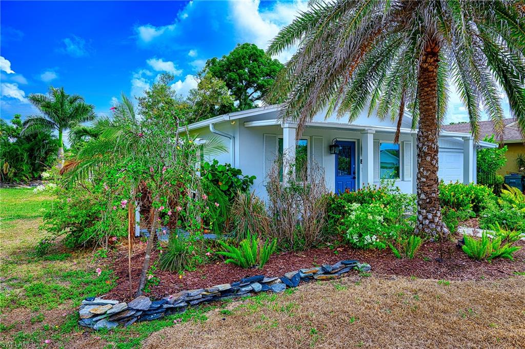 757 101st Avenue North Naples, FL 34108 - Photo 2 of 33 a front view of house with yard and green space