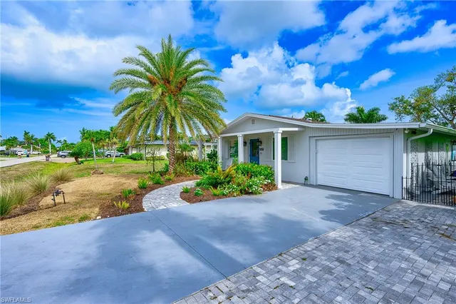 a view of house with garden and a yard