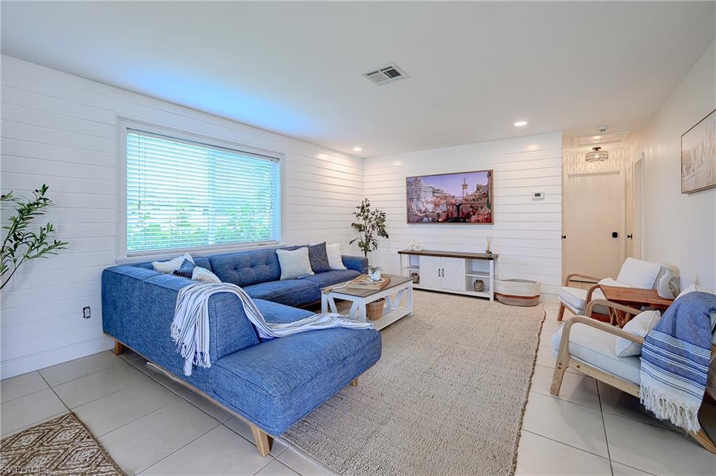 757 101st Avenue North Naples, FL 34108 - Photo 8 of 33 a living room with furniture and a large window