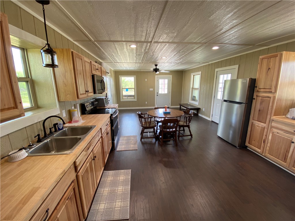 2696 Franke Road Goliad, TX 77963 - Photo 3 of 12 a kitchen with sink cabinets and refrigerator