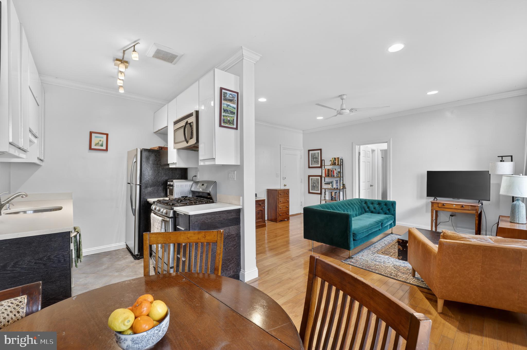 2325 42nd Street Northwest, Unit 104 Washington, DC 20007 - Photo 1 of 25 a living room with furniture and a flat screen tv