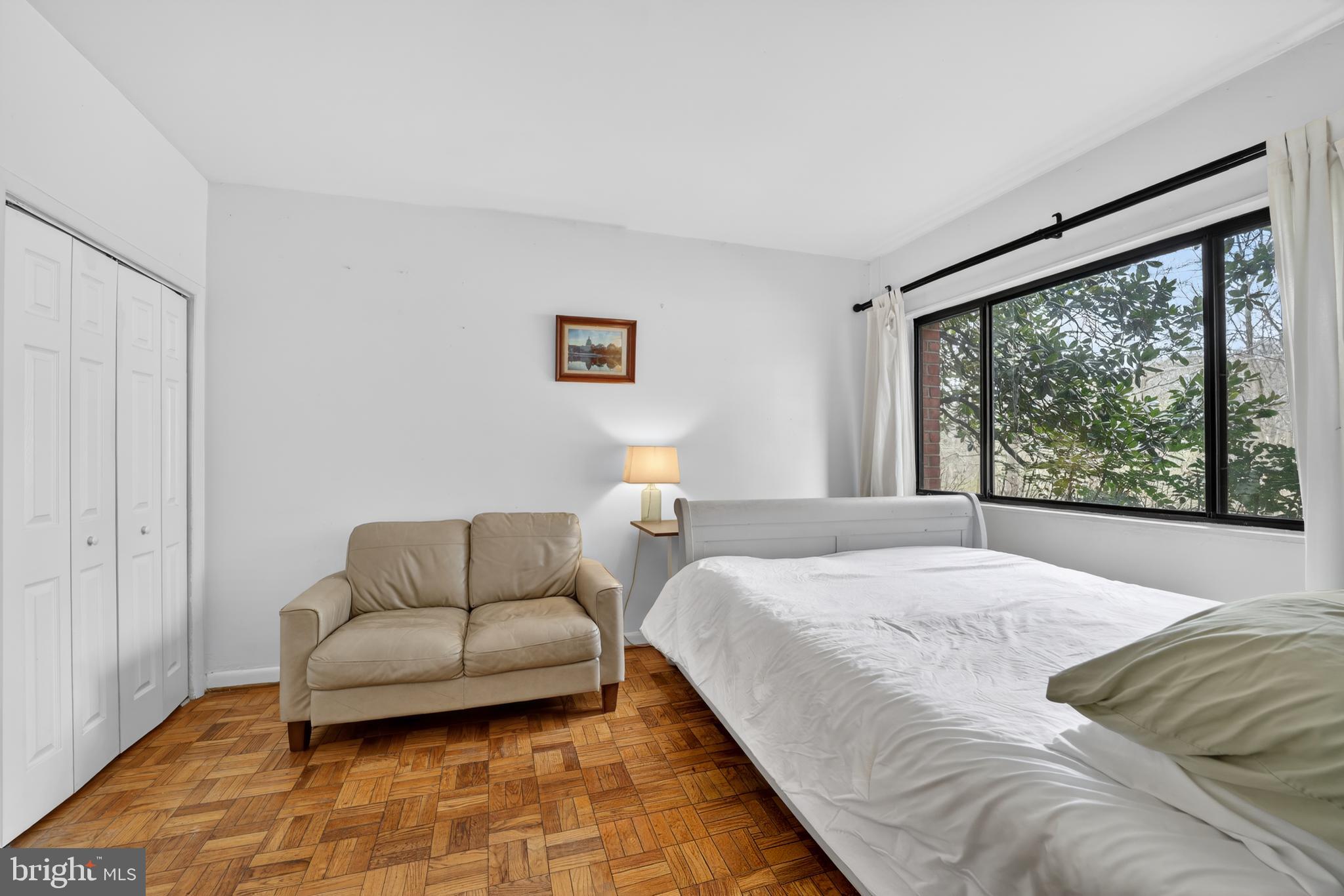 2325 42nd Street Northwest, Unit 104 Washington, DC 20007 - Photo 11 of 25 a bedroom with furniture and a large window