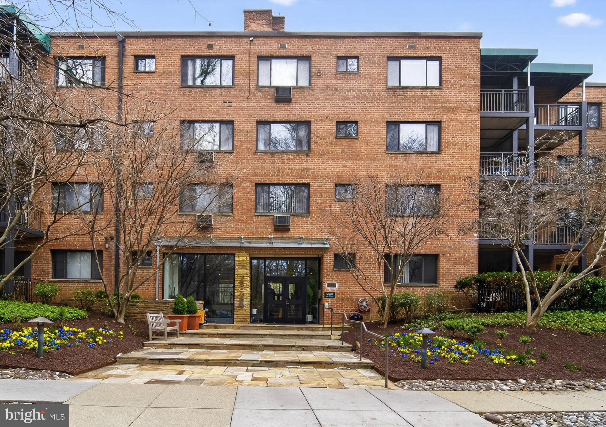 2325 42nd Street Northwest, Unit 104 Washington, DC 20007 - Photo 15 of 25 a front view of a building with garden