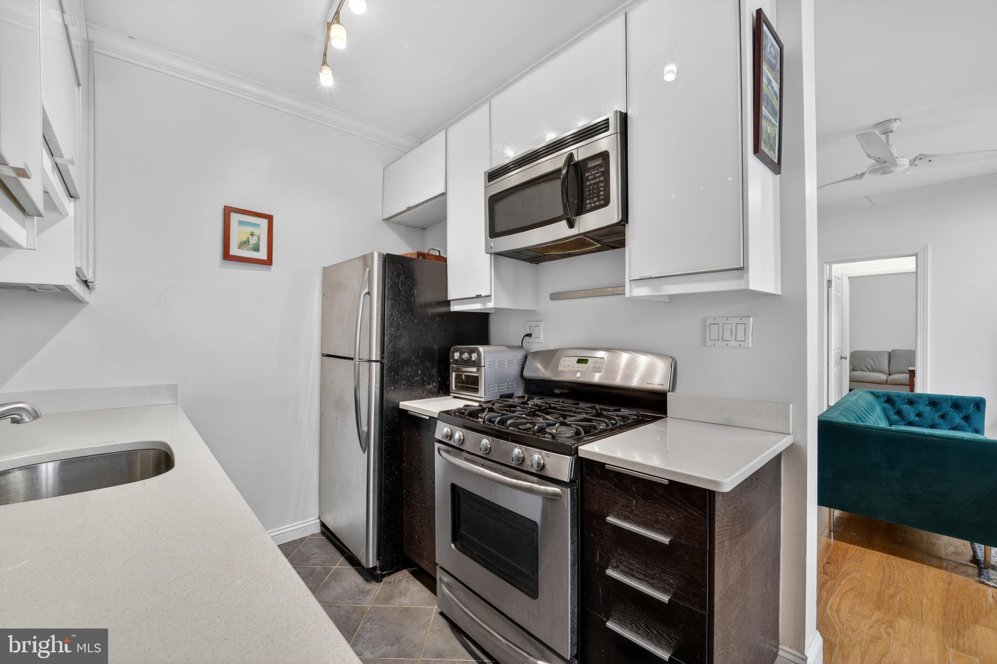 2325 42nd Street Northwest, Unit 104 Washington, DC 20007 - Photo 2 of 25 a kitchen with stainless steel appliances a refrigerator stove and microwave