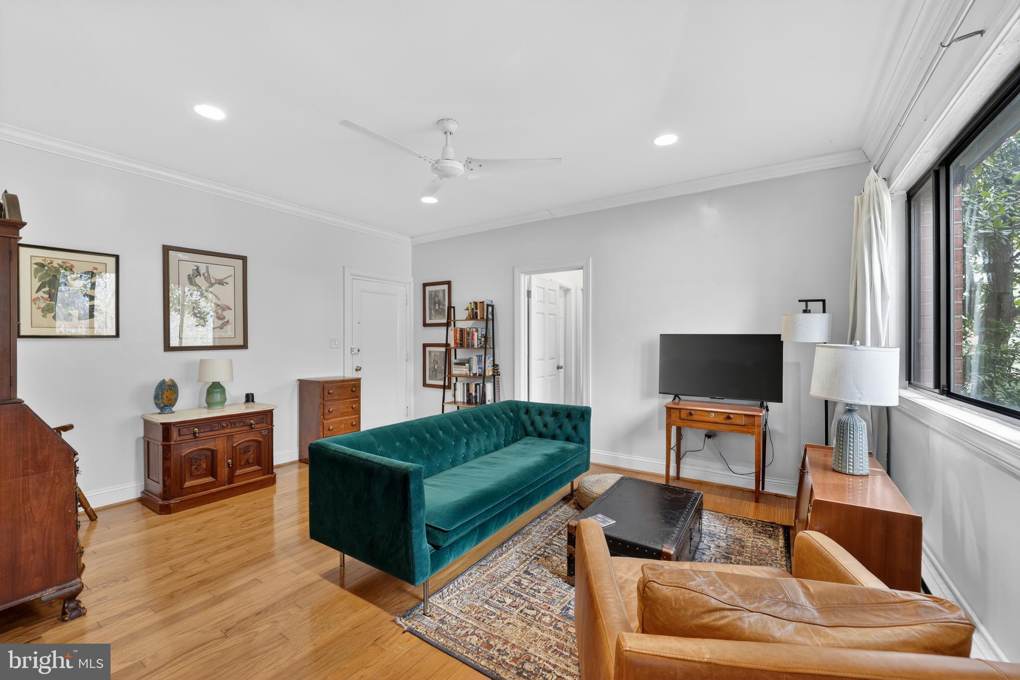 2325 42nd Street Northwest, Unit 104 Washington, DC 20007 - Photo 5 of 25 a living room with furniture a flat screen tv and a fireplace