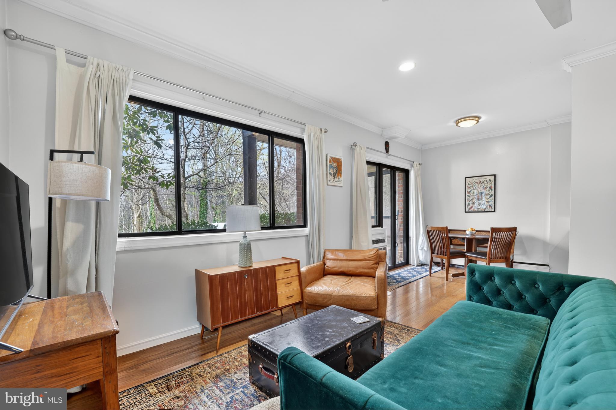 2325 42nd Street Northwest, Unit 104 Washington, DC 20007 - Photo 7 of 25 a living room with furniture and a large window