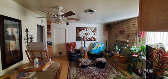 828 Kinnett Avenue Ridgecrest, CA 93555 - Photo 11 of 13 a room with furniture and a potted plant