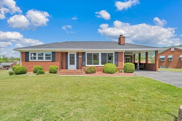 a view of a house with a backyard and porch