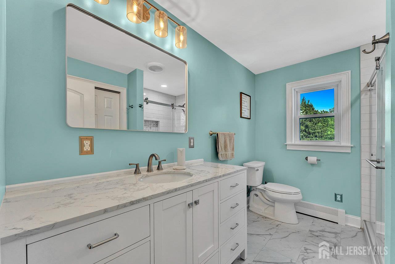254 Friendship Road Monmouth Junction, NJ 08852 - Photo 12 of 33 a bathroom with a toilet sink and mirror