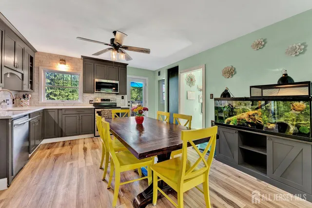 a kitchen with stainless steel appliances kitchen island granite countertop a stove a sink and a refrigerator