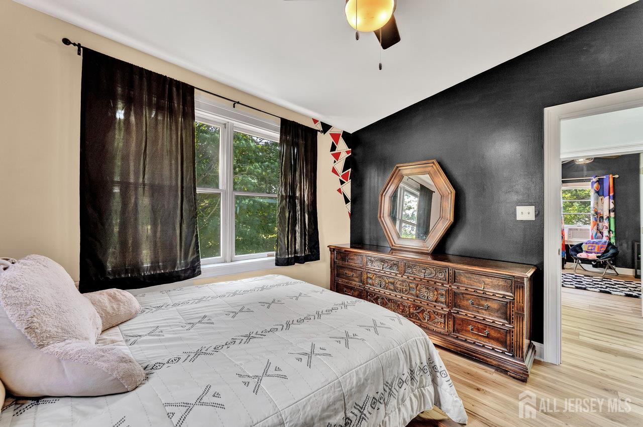 254 Friendship Road Monmouth Junction, NJ 08852 - Photo 19 of 33 a bedroom with a bed a mirror on dresser and a large window