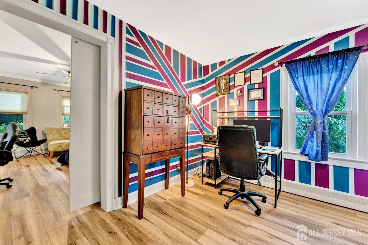254 Friendship Road Monmouth Junction, NJ 08852 - Photo 22 of 33 a view of a hallway with workspace and wooden floor