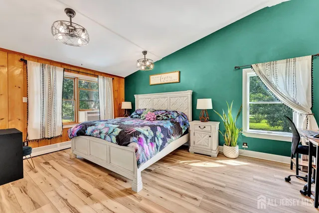 a bedroom with a bed and a large window