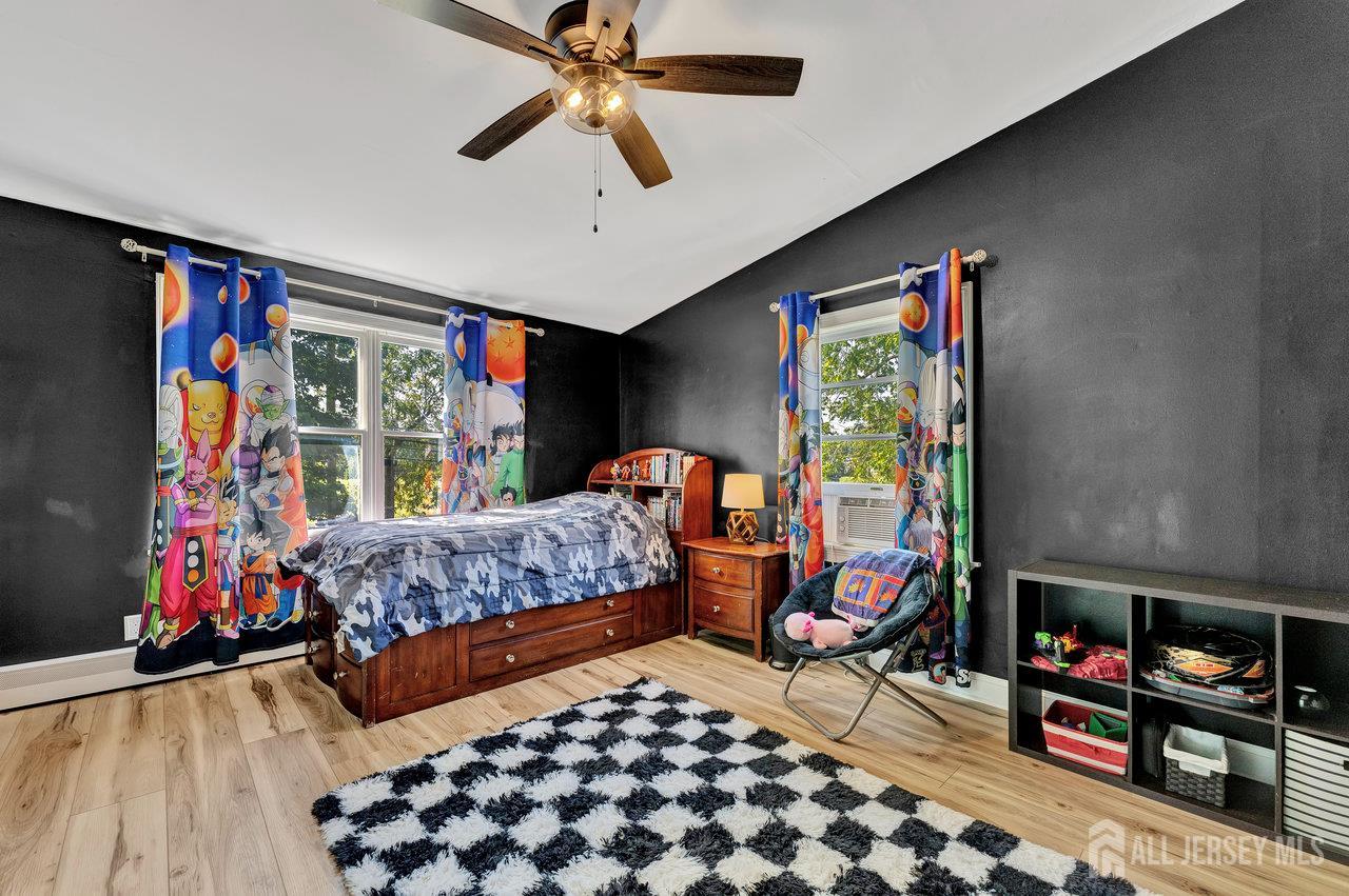 254 Friendship Road Monmouth Junction, NJ 08852 - Photo 25 of 42 a bedroom with furniture and a flat screen tv