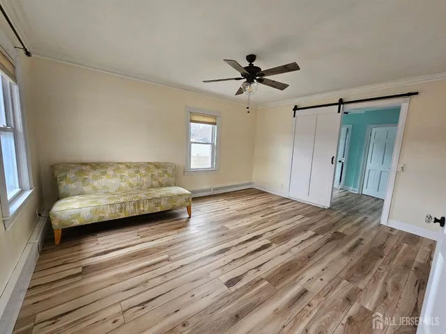 a view of a bedroom with furniture and a ceiling fan