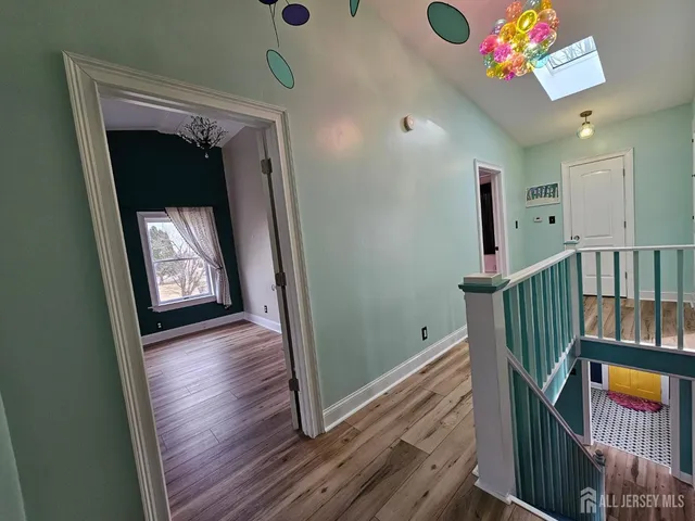 a view of an entryway door and wooden floor