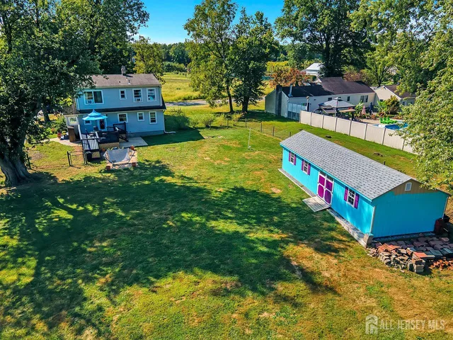 swimming pool with outdoor seating and yard