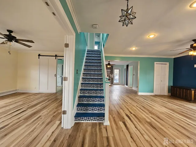 a view of a room with wooden floor and stairs