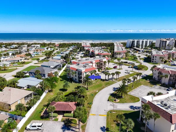 an aerial view of residential houses with outdoor space