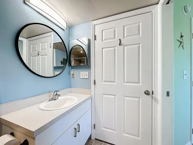 a bathroom with a toilet a sink and a mirror