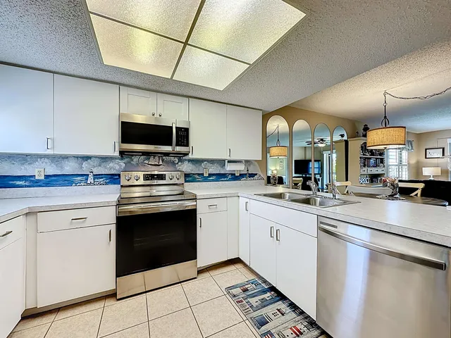 a kitchen with a sink cabinets and stainless steel appliances