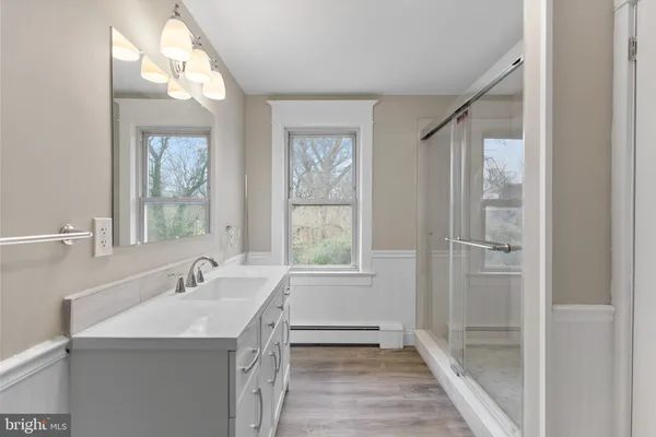 a bathroom with a sink a mirror and a bathtub