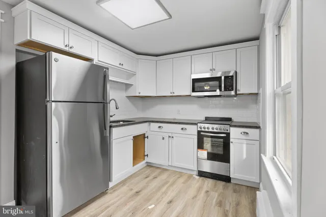 a kitchen with a refrigerator stove and microwave