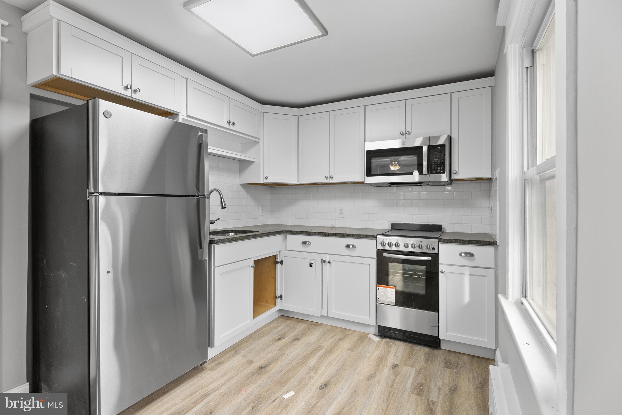 818 Stiles Avenue Maple Shade, NJ 08052 - Photo 4 of 11 a kitchen with a refrigerator stove and microwave