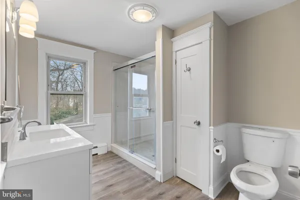 a bathroom with a toilet sink and shower