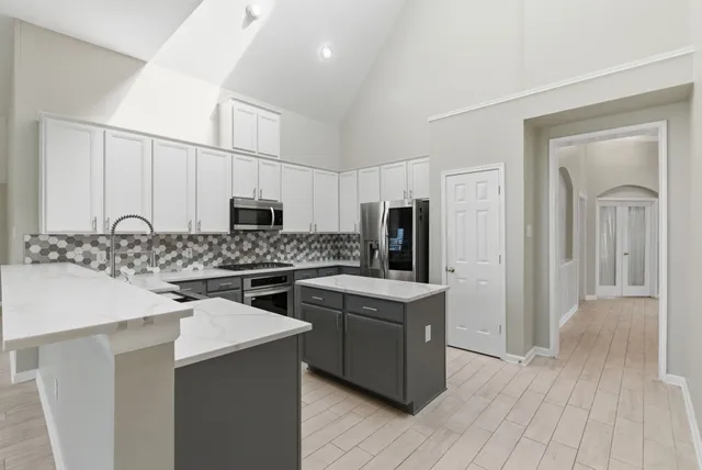 a kitchen with a sink stove and refrigerator
