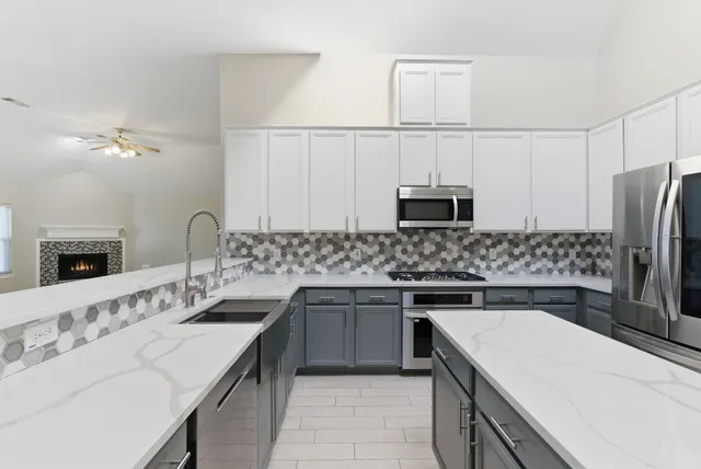 a kitchen with a sink and stainless steel appliances