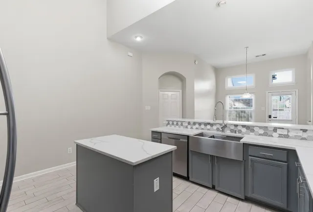 a kitchen with a sink and stove