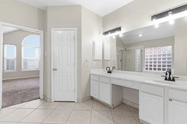 a bathroom with a double vanity sink mirror and a