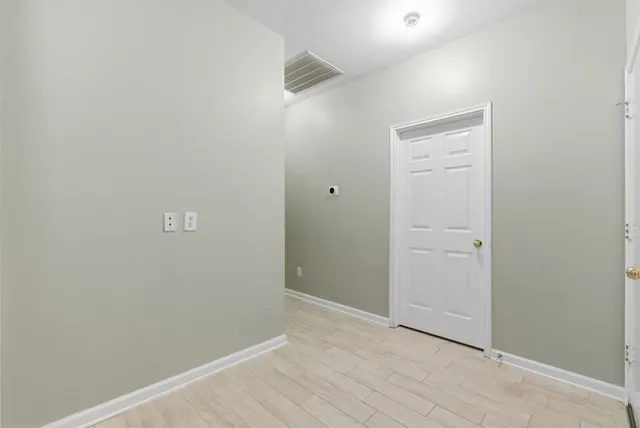 a view of an empty room with a fan