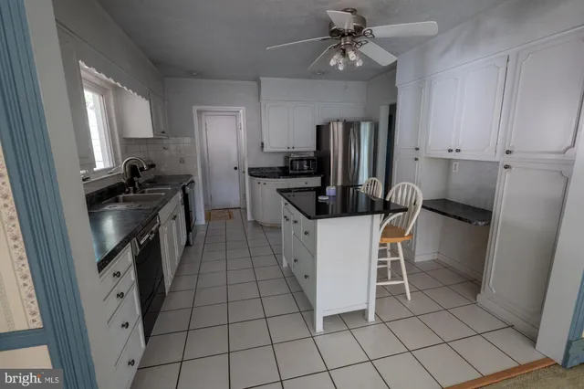 a view of a livingroom with wooden floor and a window