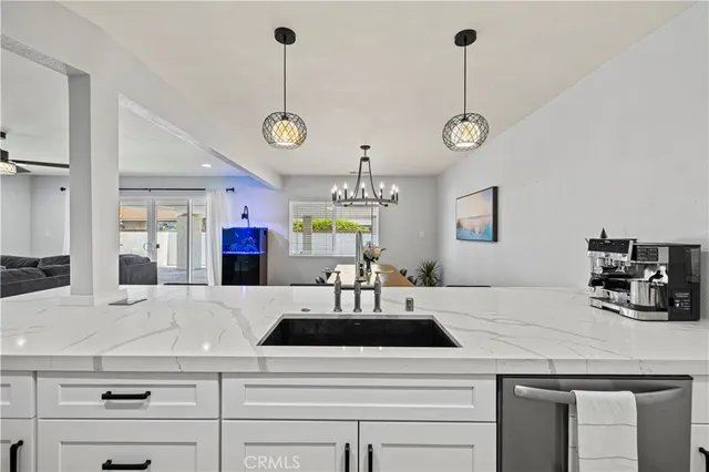a kitchen with a counter space a sink and cabinets